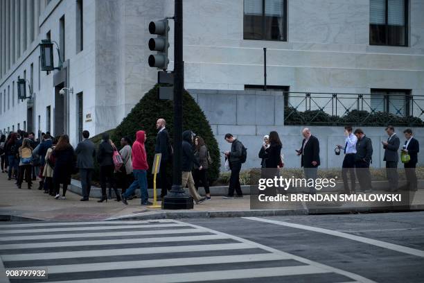 People wait in a long security line to enter the Dirksen Senate Office Building on Capitol Hill while the US government is shutdown January 22, 2018...