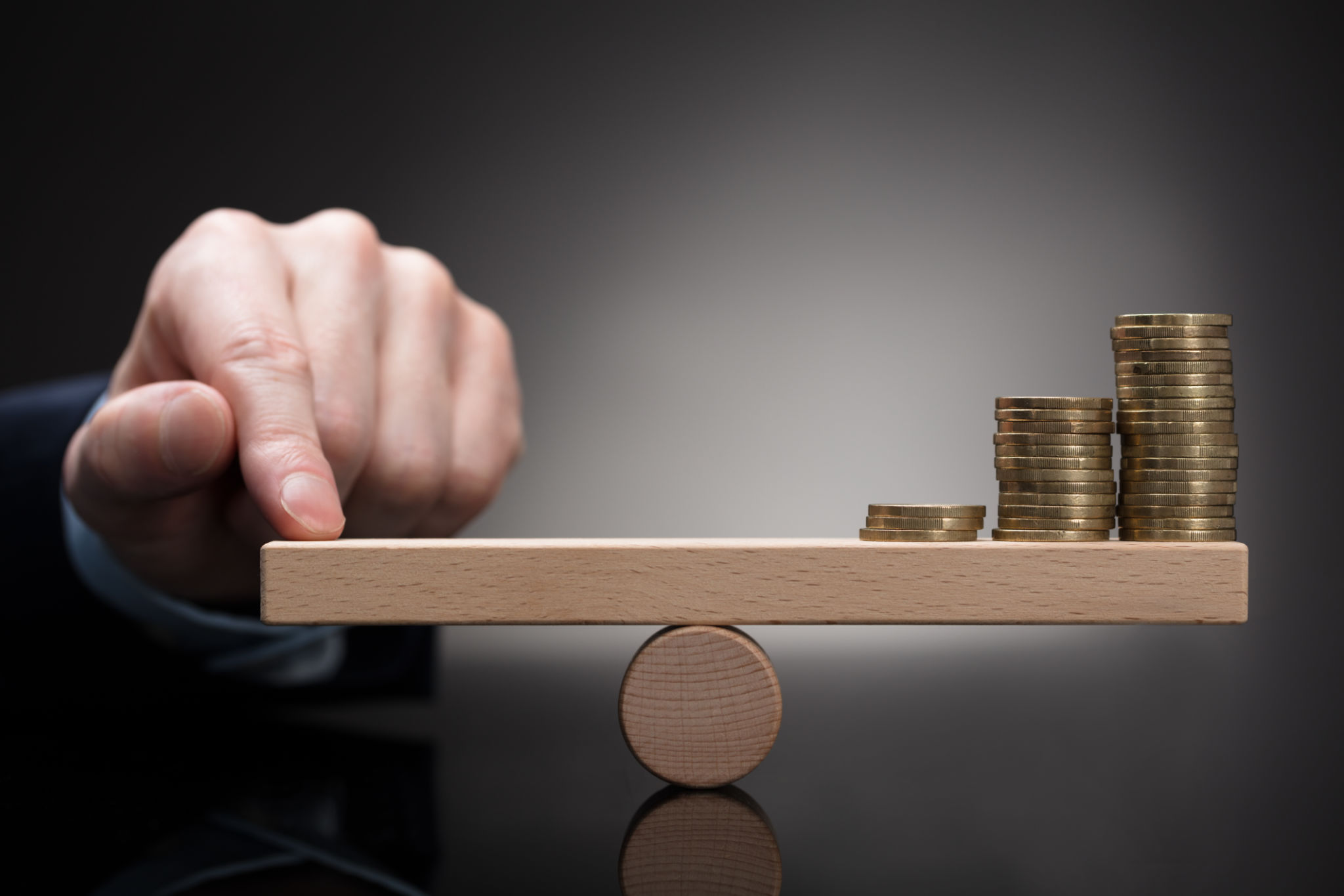 Finger Balancing Stacked Coins On Seesaw Finger Balancing Stacked Coins On Seesaw