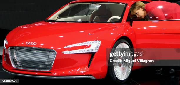 German Chancellor Angela Merkel takes a look at the Audi R8 E-Tron Concept car during the international motor show IAA on September 17, 2009 in...