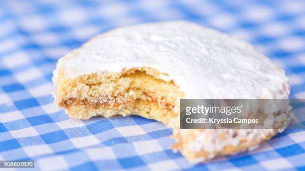 close up of sweet cookies filled with caramel - alfajores foto e immagini stock