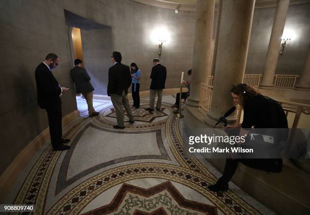Reporters wait outside of a closed door Senate Republican meeting, at the U.S. Capitol on January 22, 2018 in Washington, DC. A bipartisan group of...