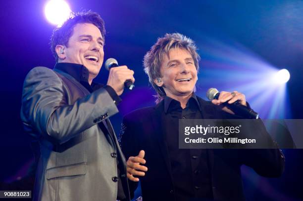 John Barrowman and Barry Manilow perform on stage as part of the BBC Proms In The Park at Hyde Park on September 12, 2009 in London, England.