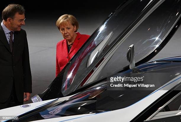 German carmaker BMW's CEO Norbert Reithofer shows the BMW Vision Efficient Dynamics concept car to German Chancellor Angela Merkel at the BMW...