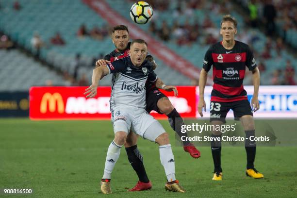 January 19: Besart Berisha of the Victory is challenged in this tackle by Wanderers Josh Risdon during the round 17 A-League match between the...