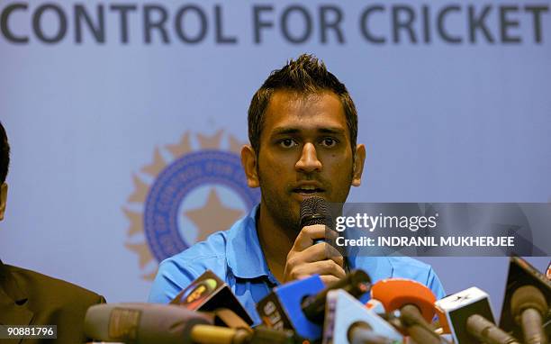 Indian cricket captain Mahendra Singh Dhoni speaks at a pre-departure press conference in Mumbai on September 17, 2009. The Indian cricket team led...