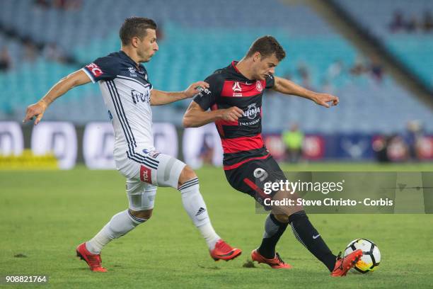 January 19: Oriol Riera of the Wanderers celebrates is challenged in this tackle by Victory's Kostas Barbarouses during the round 17 A-League match...