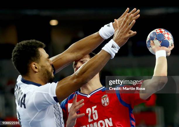 Nemanja Zelenovic of Serbia challenges Adrien Dipanda of France during the Men's Handball European Championship main round match between Serbia and...