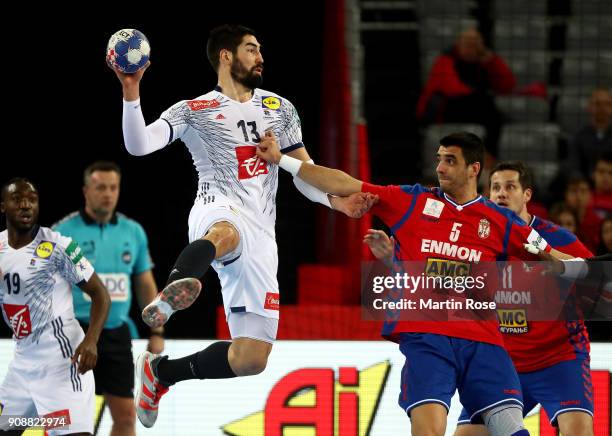 Zarko Sesum of Serbia challenges Nikola Karabatic of France during the Men's Handball European Championship main round match between Serbia and...