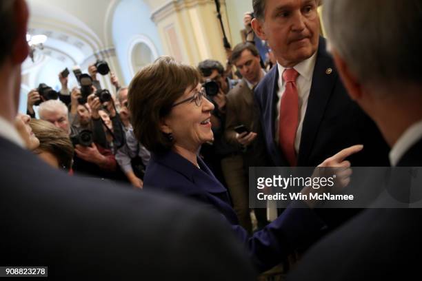 Sen. Susan Collins and Sen. Joe Manchin gather with a bipartisan group of senators in the U.S. Capitol following a key vote to end the shutdown of...