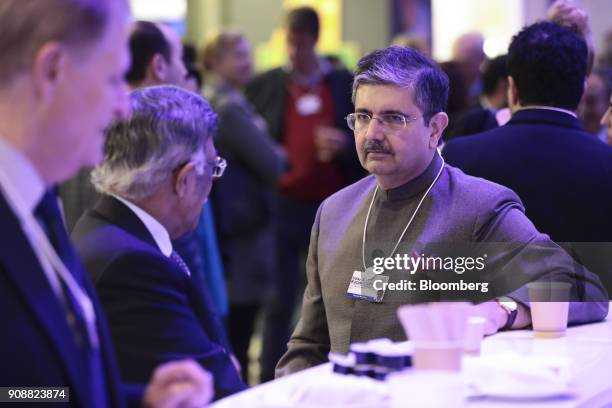Uday Kotak, billionaire and chairman of Kotak Mahindra Bank Ltd., right, speaks to an attendee ahead of the World Economic Forum in Davos,...