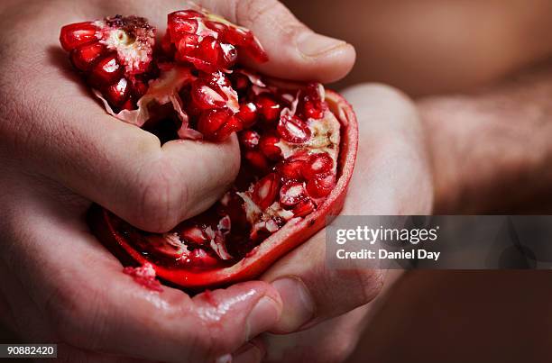 man holding fruit - pomegranate stock pictures, royalty-free photos & images