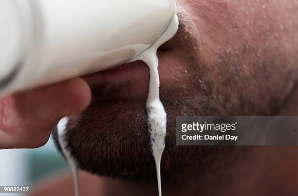 man drinking milk - spilled drink stock pictures, royalty-free photos & images