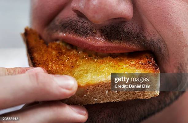 man eating bread - brot mund stock-fotos und bilder