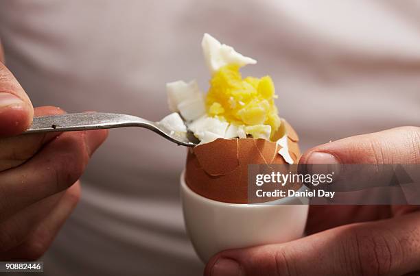 man eating hard boiled egg - kokat ägg bildbanksfoton och bilder