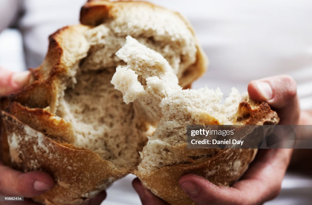 Man breaking bread 