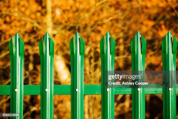 a fence around swithland reservoir, leicestershire, uk. - spiked stock pictures, royalty-free photos & images