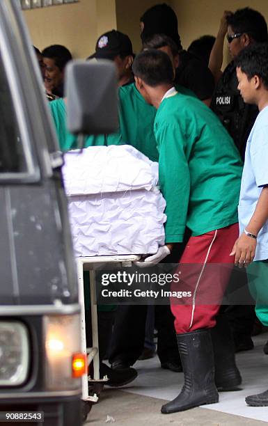 The body of a militant killed in a raid is carried in to Kramatjati hospital on September 17, 2009 in Jakarta, Indonesia. Indonesian police raided a...