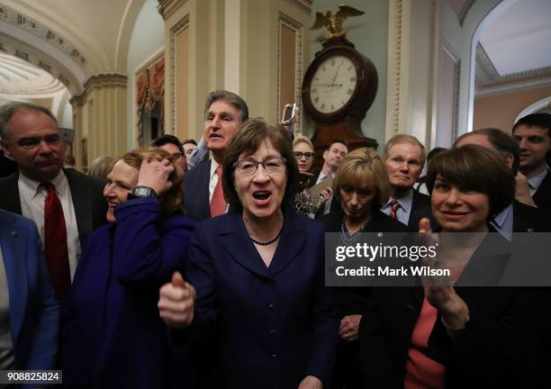 Sen. Susan Collins , celebrates with fellow Senators after the Senate voted and passed the a CR to reopen the government, at the U.S. Capitol on...