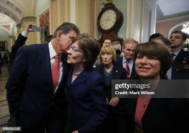 Sen. Joe Manchin , , kisses Sen. Susan Collins , as they celebrate with fellow Senators after the Senate voted and passed the a CR to reopen the...