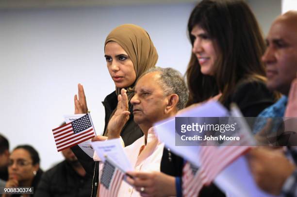 Immigrants take the oath of citizenship to the United States at a naturalization service on January 22, 2018 in Newark, New Jersey. Although much of...