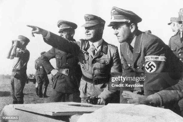 Albert Speer , German Minister of Armaments and War Production for the Third Reich, with officers of the Organisation Todt military engineering group...