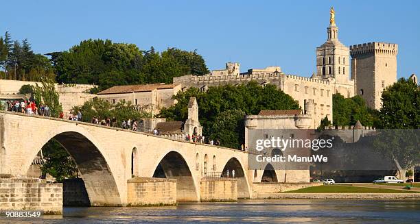 bridge of avignon with popes palace front - french pope stock pictures, royalty-free photos & images