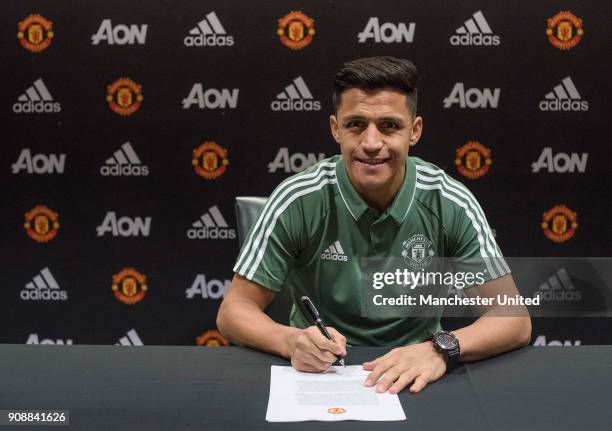 Alexis Sanchez of Manchester United poses after signing for the club at Old Trafford on January 22, 2018 in Manchester, England.