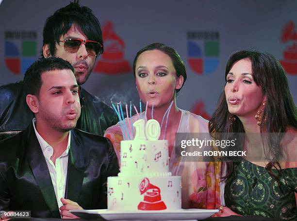 Urban artist Tito �El Bambino,� singer Beto Cuevas, singer/songwriter Shaila Durcal and television personality Giselle Blondet blow out the candles...