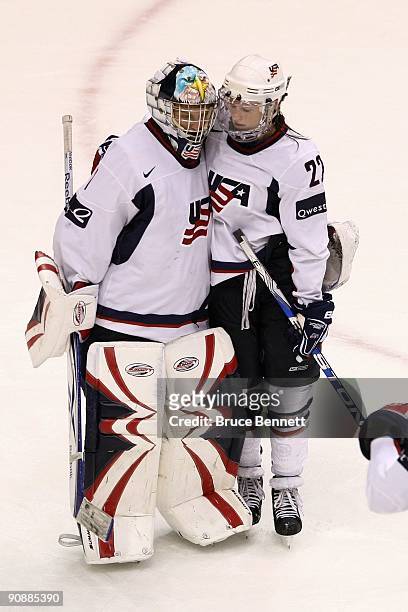 Kacey Bellamy of Team USA congratulates teammate Molly Schaus following the game against Team Canada during the Hockey Canada Cup at General Motors...