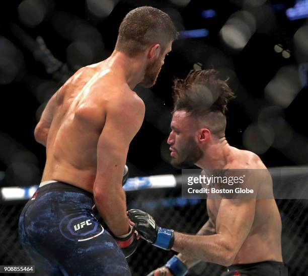 Calvin Kattar, left, drops Shane Burgos to the canvas en route to a win in a Featherweights match during UFC 220 at TD Garden in Boston on Jan. 20,...