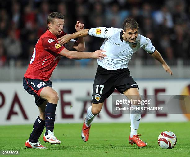 Lille's midfielder Stephane Dumont vies with Valencia's forward Joaquin Sanchez during the Europa league football match Lille vs Valence on September...