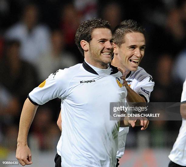 Valencia's forward Mata Juan is congratulated by his team mates after scoring a goal during the Europa league football match Lille vs Valence on...