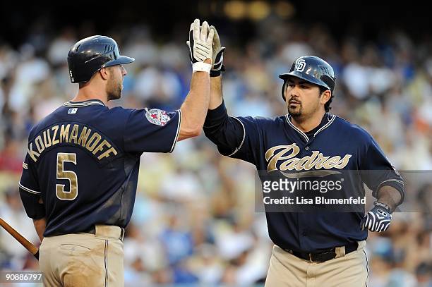 Adrian Gonzalez is congratulated by teammate Kevin Kouzmanoff of the San Diego Padres after hitting a homerun in the fifth inning against the Los...