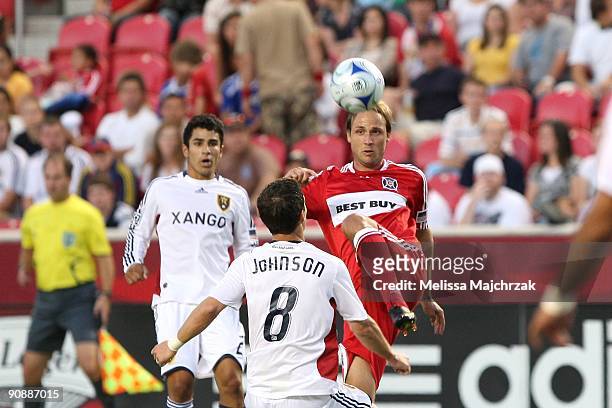 Justin Mapp of Chicago Fire goes up for the ball against Will Johnson of Real Salt Lake at Rio Tinto Stadium on September 12, 2009 in Sandy, Utah.