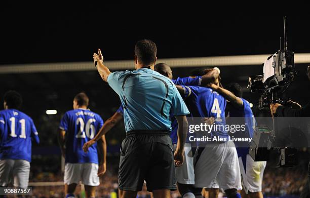 The Additional Assistant Referee gestures away the celebrating Everton players after a Joseph Yobo goal during the UEFA Europa League Group I match...