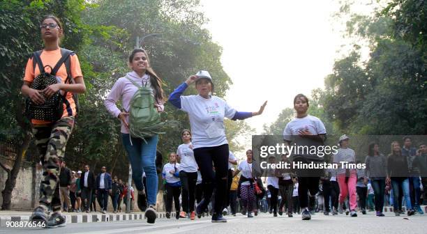 Young girls participate during Women Marathon to raise a voice against the tax on sanitary napkins at Delhi University North Campus on January 22,...