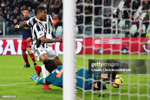 Douglas Costa of Juventus beats Mattia Perin of Genoa CFC to score the opening goal during the Serie A match between Juventus and Genoa CFC at...