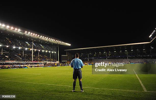 The Additional Assistant Referee watches the action from behind the goal line during the UEFA Europa League Group I match between Everton and AEK...