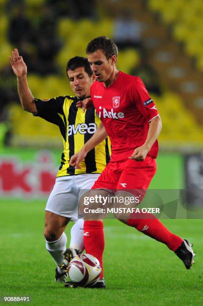 Emre Belozoglu of Fenerbahce competes with Wout Brama of Twente during the UEFA Europa League Group 1 match at Sukru Saracoglu stadium in Istanbul on...