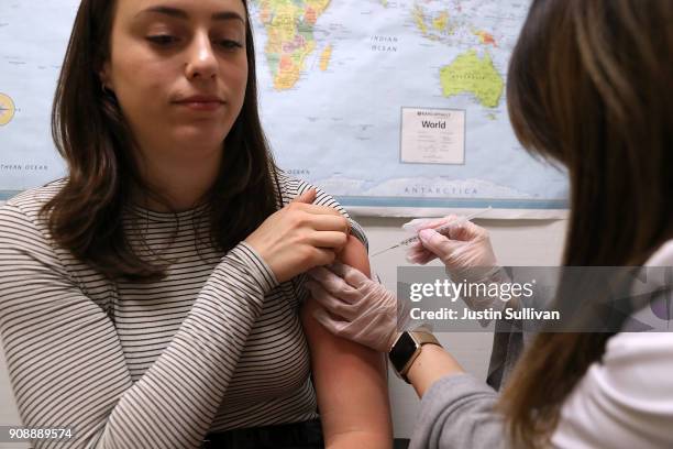 Simone Groper receives a flu shot at a Walgreens phramacy on January 22, 2018 in San Francisco, California. A strong strain of H3N2 influenza has...