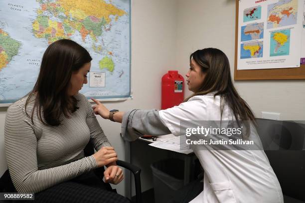 Simone Groper prepares to receive a flu shot at a Walgreens phramacy on January 22, 2018 in San Francisco, California. A strong strain of H3N2...