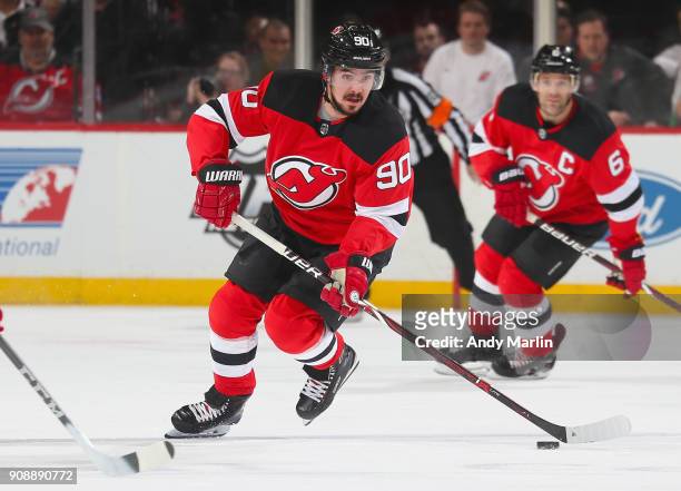 Marcus Johansson of the New Jersey Devils plays the puck during the game against the Washington Capitals at Prudential Center on January 18, 2018 in...