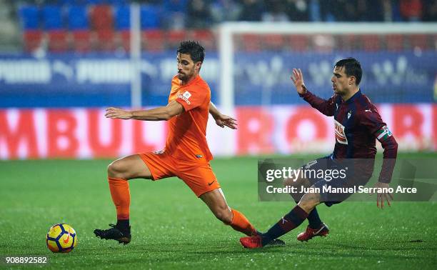 Daniel Garcia of SD Eibar duels for the ball with Adrian Gonzalez of Malaga CF during the La Liga match between SD Eibar and Malaga CF at Ipurua...