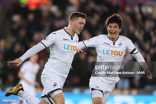 Alfie Mawson of Swansea City celebrates after scoring a goal to make it 1-0 during the Premier League match between Swansea City and Liverpool at...
