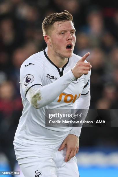 Alfie Mawson of Swansea City celebrates after scoring a goal to make it 1-0 during the Premier League match between Swansea City and Liverpool at...