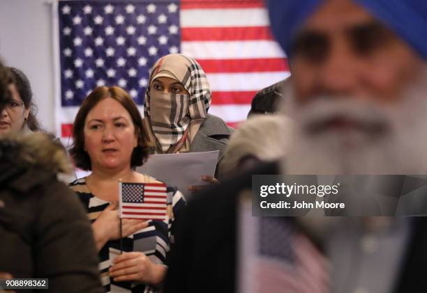 New American citizens recite the pledge of allegiance to the United States at a naturalization service on January 22, 2018 in Newark, New Jersey....