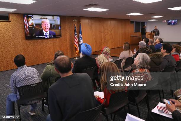 President Donald Trump addresses new American citizens on a taped video shown at a naturalization ceremony on January 22, 2018 in Newark, New Jersey....