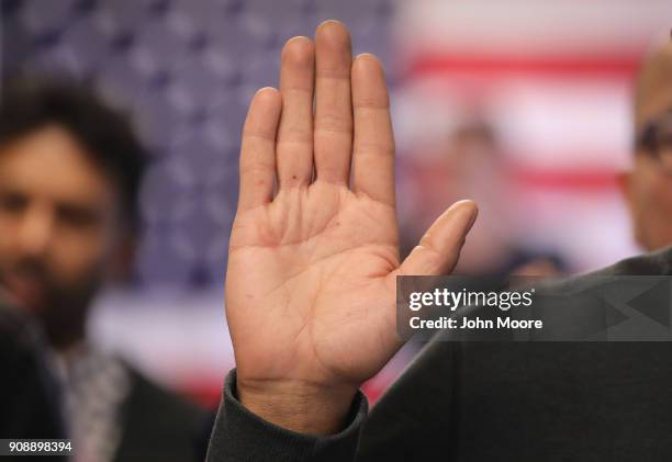 Immigrants take the oath of allegiance to the United States at a naturalization ceremony on January 22, 2018 in Newark, New Jersey. Immigrants from...