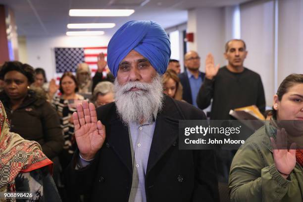 Indian immigrant Darshan Darshan takes the oath of allegiance to the United States at a naturalization ceremony on January 22, 2018 in Newark, New...