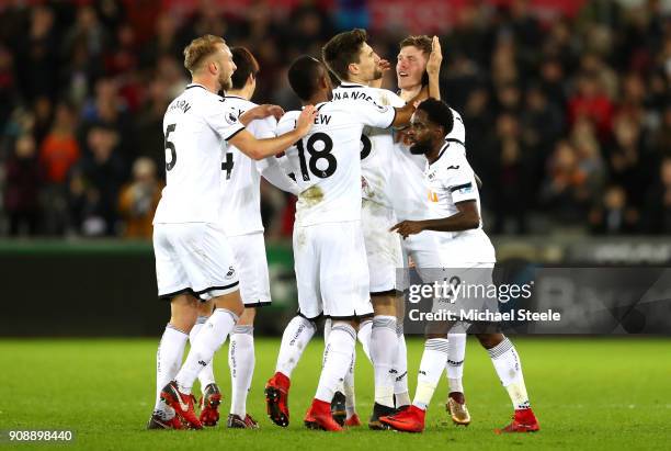 Alfie Mawson of Swansea City celebrates scoring his side's first goal with team mates during the Premier League match between Swansea City and...